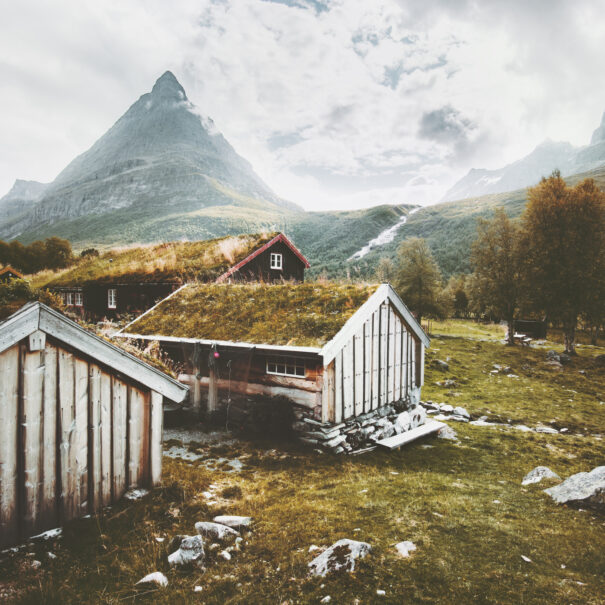 Innerdalen Mountains valley Landscape and traditional norwegian houses grass roofs farm village in Norway Travel scenery scandinavian wooden architecture